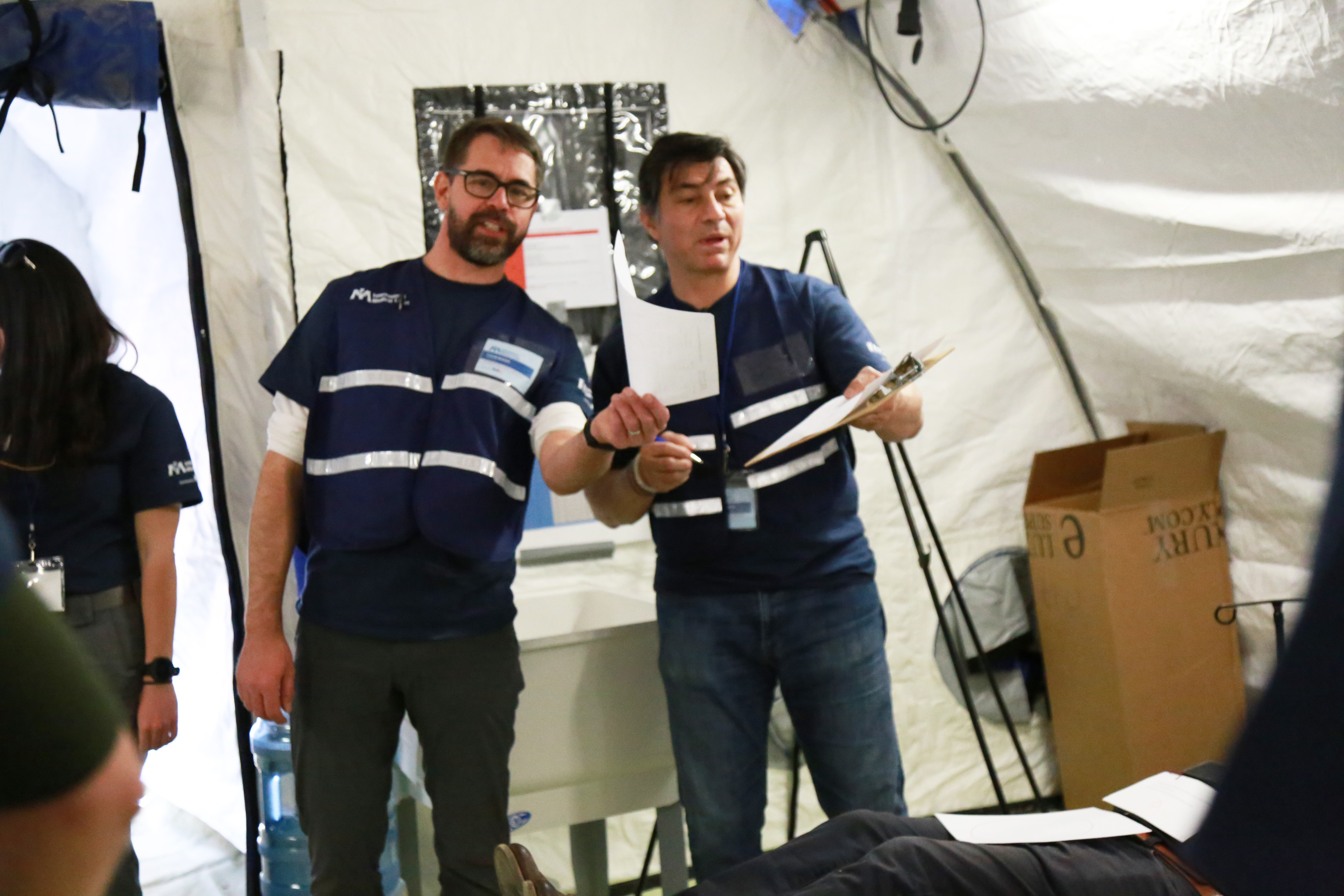 Dr. Colin Bucks (L), Clinical Assistant Professor, Emergency Medicine, Stanford, and Dr. Hernando Garzon (R), Global Health Program Director, Kaiser Permanente, participate in the field hospital simulation.