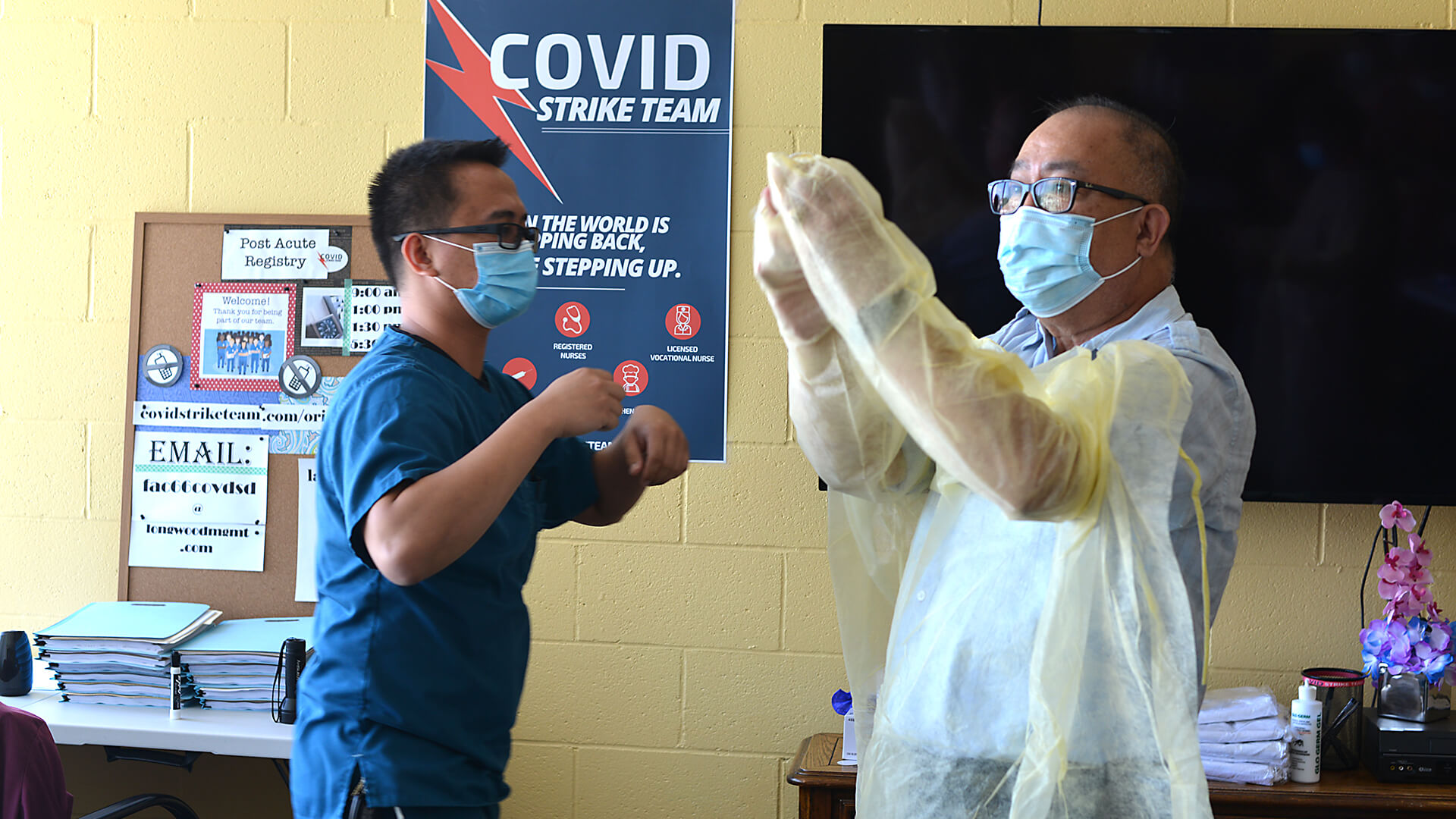 Volunteers participate in a COVID-19 demonstration at the Eastland Subacute and Rehabilitation Center in El Monte, California.