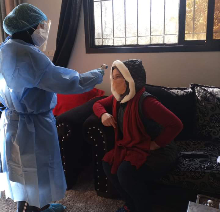 Roukaya Ayach, a nurse with the COVID-19 homecare team, takes the vital signs of a patient at the patient’s home.