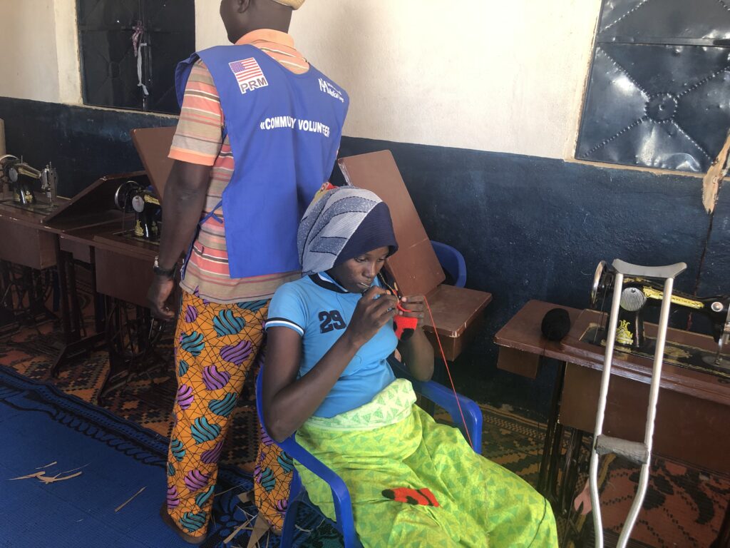 An adolescent girl living with disability participates in vocational training at International Medical Corps' Youth Empowerment Center in Minawao camp, Cameroon.