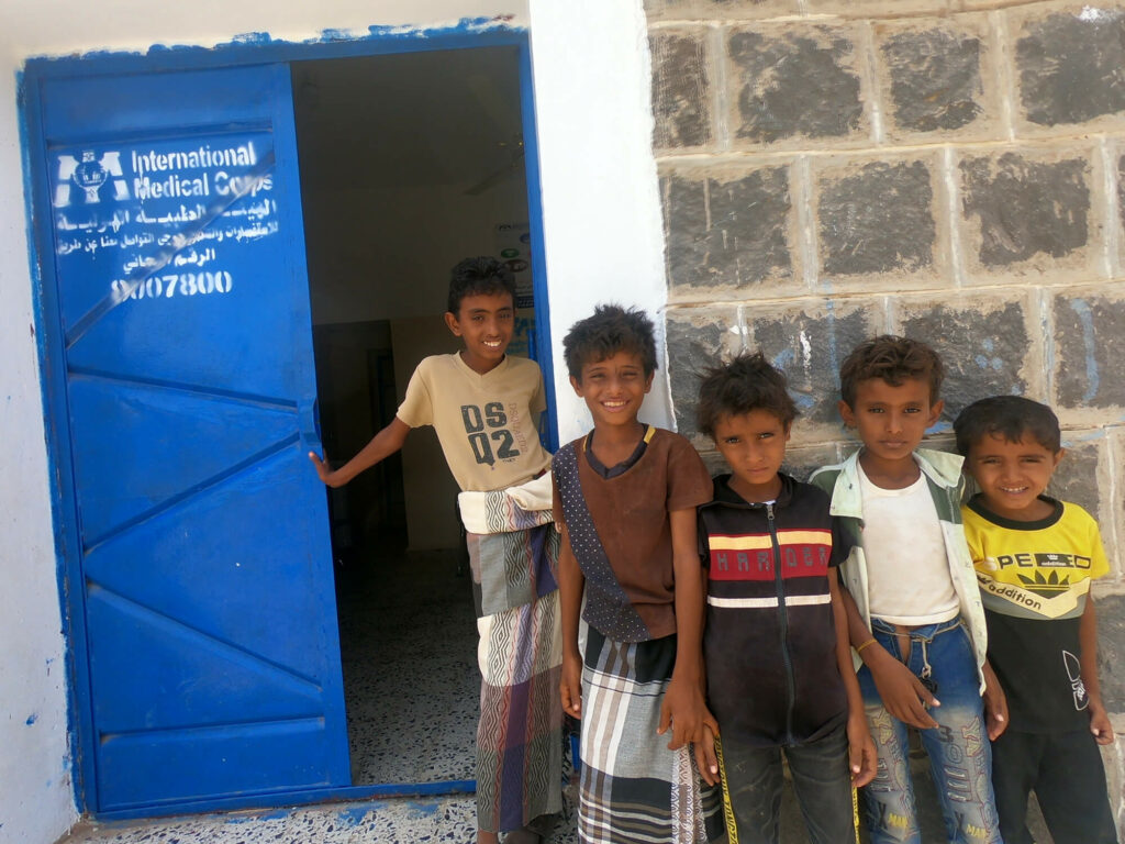 Local children pose at the entrance to a primary healthcare clinic we recently renovated in the village of Hessi Salem, north of Al-Mukha.