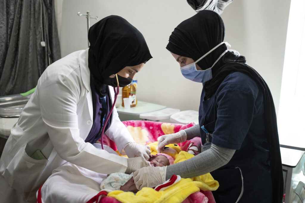 International Medical Corps Doctor checks on a baby, in the International Medical Corps Maternity Ward, Irbid Specialty Hospital, Irbid, Jordan.
