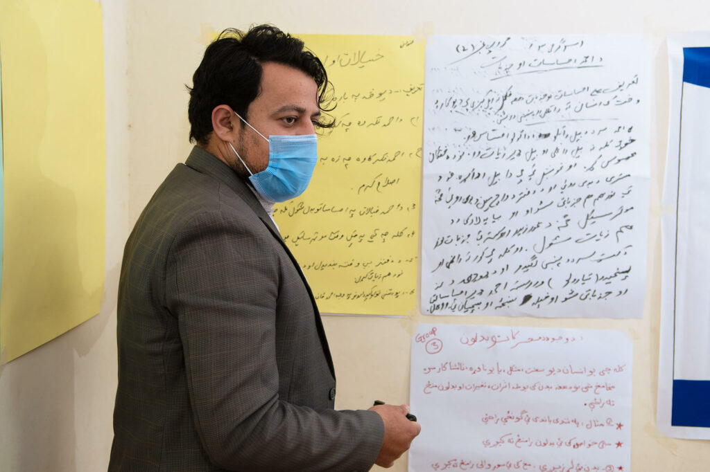 Abdullah presents his work to other participants during an EMAP session. He now advocates for women’s rights in his community and works to combat violence against women.