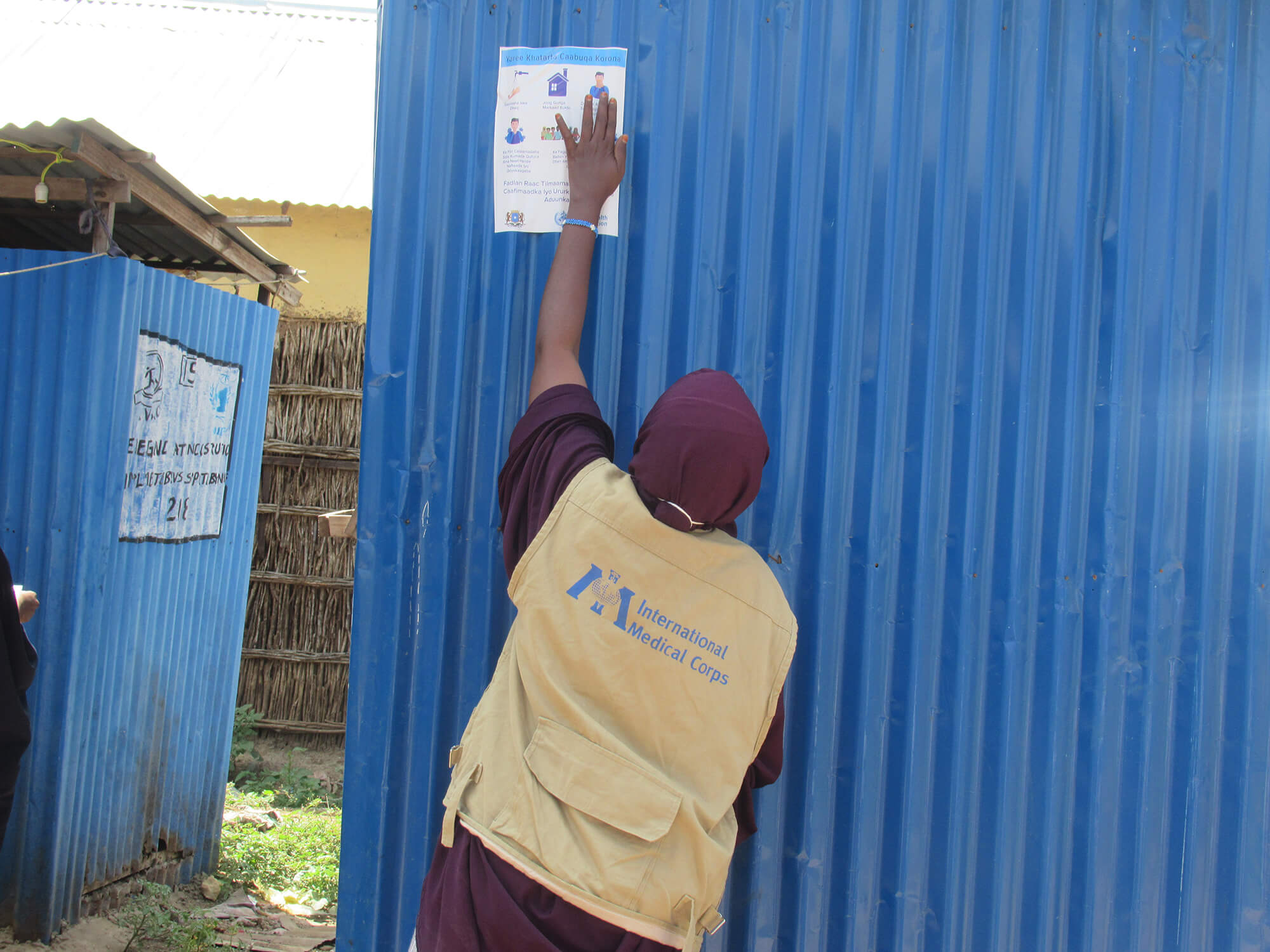A health worker spreads awareness to the community about COVID-19 in an IDP camp in Somalia.