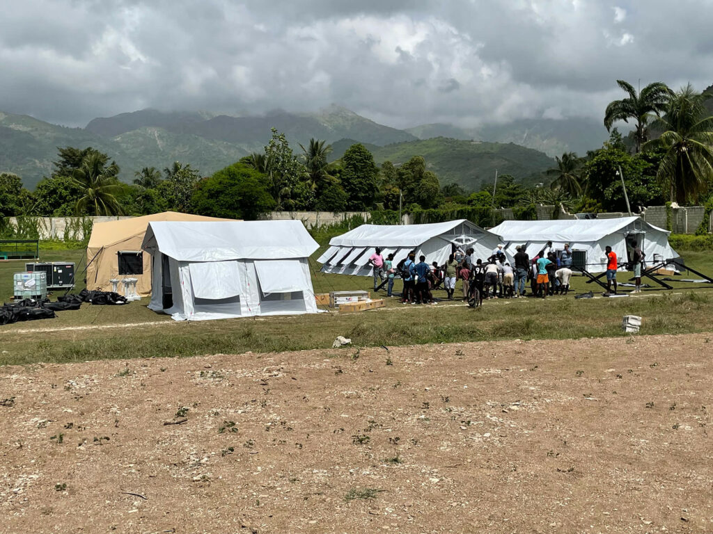 With the help of staff, volunteers and local community members, International Medical Corps overcame a mammoth logistical challenge and set up its EMT in Aquin, Haiti, in a matter of days.