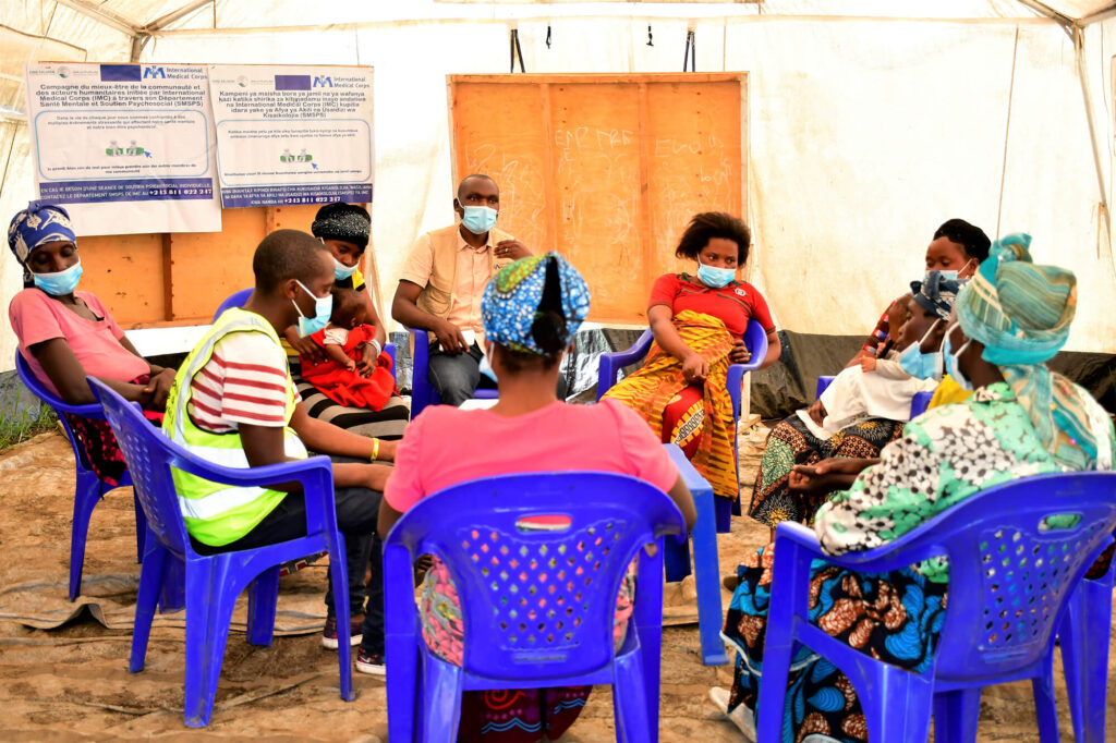 International Medical Corps staff and volunteers lead a psychosocial support group session for residents of Mujoga camp after the 2021 eruption of Mount Nyiragongo near Goma, a town in the Democratic Republic of the Congo.