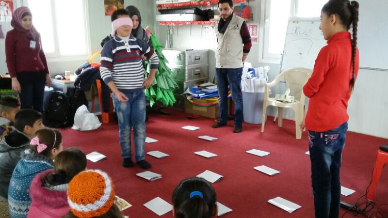 Hamsa Mohammed conducts an activity for kids in a child-friendly space.