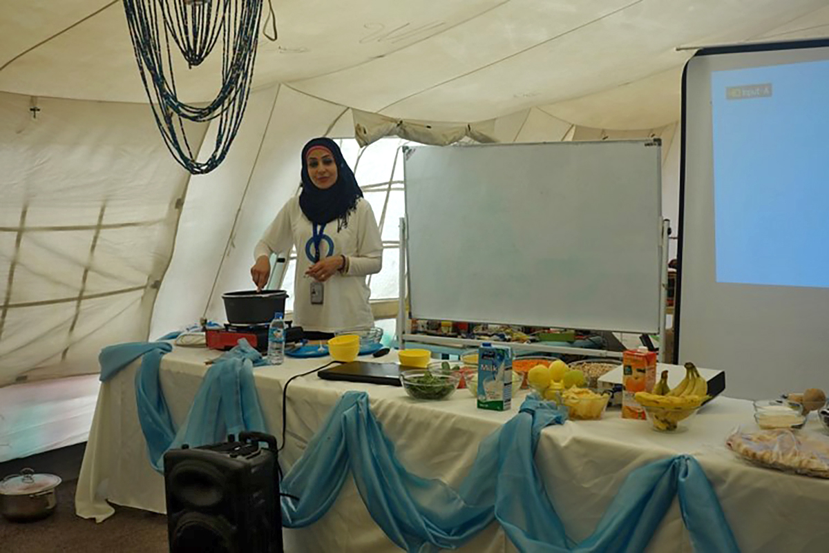 Hamsa Mohammed prepares a cooking demonstration during an event for people with diabetes.