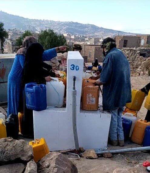 Residents draw water from a rebuilt solar-powered water point in the Al Dahera area of Al-Dhalea governorate.