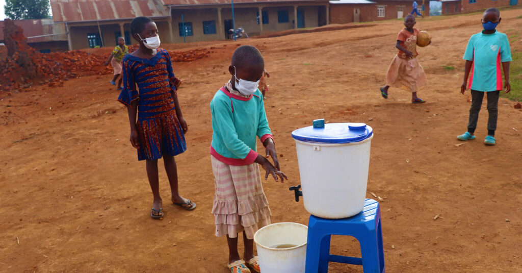 Six-year-old Jacqueline demonstrates good handwashing skills at a child-friendly space in Butembo, DRC.