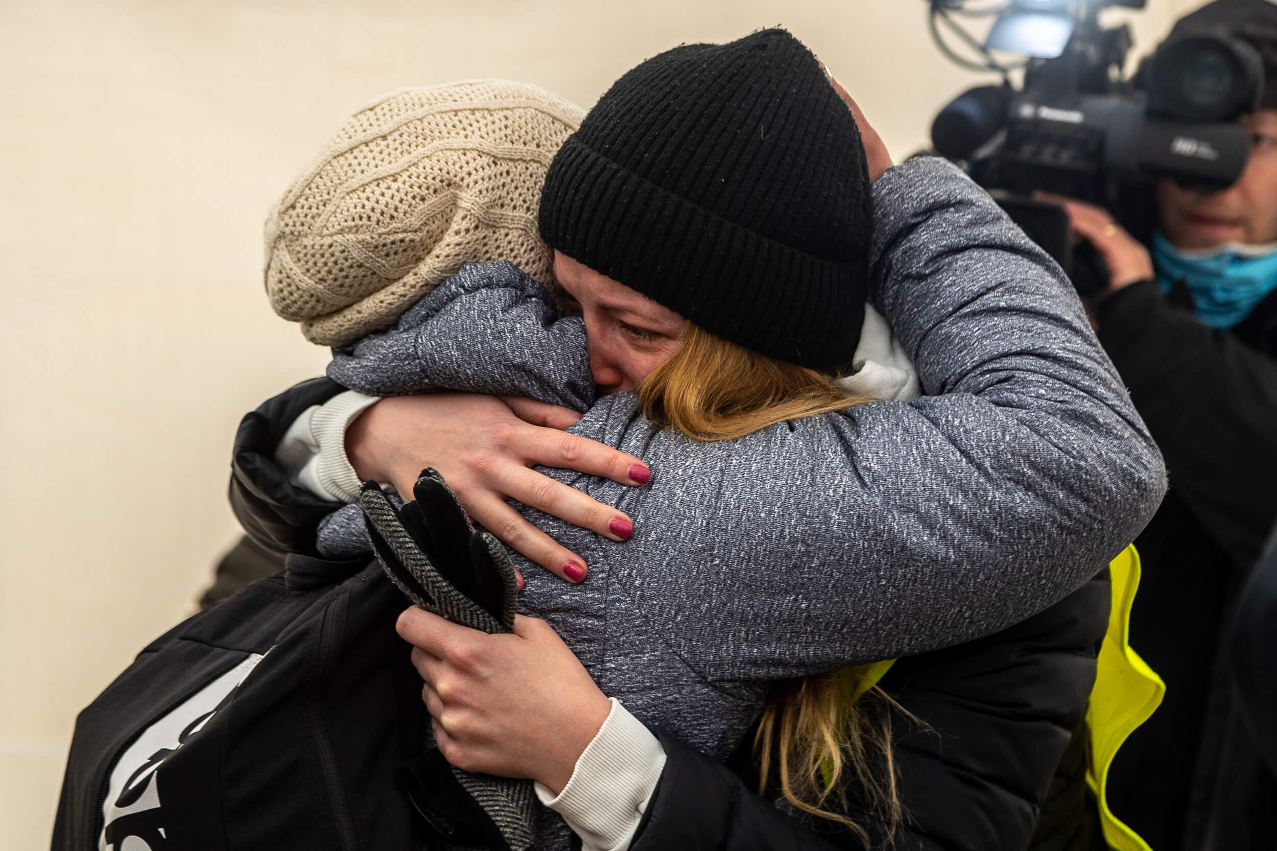 A volunteer emotionally embraces an acquaintance who has just arrived from Ukraine with a fervor that can be gained only through shared trauma.