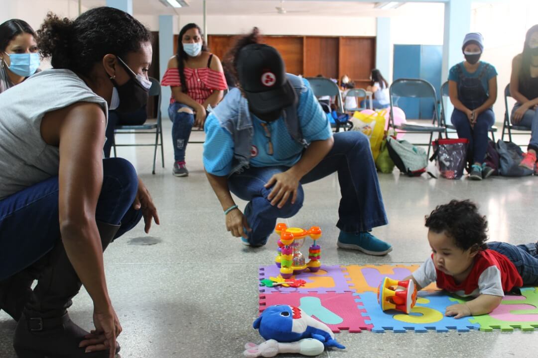 Parents and children participate in an early childhood development session.