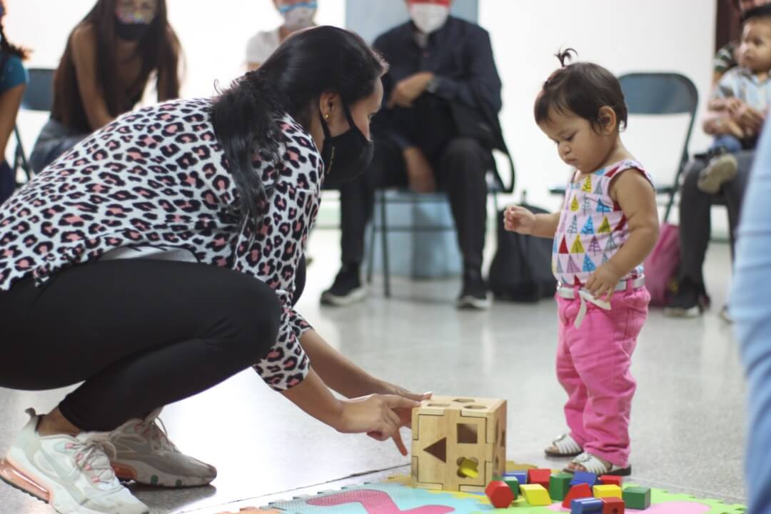 Parents and children participate in an early childhood development session.