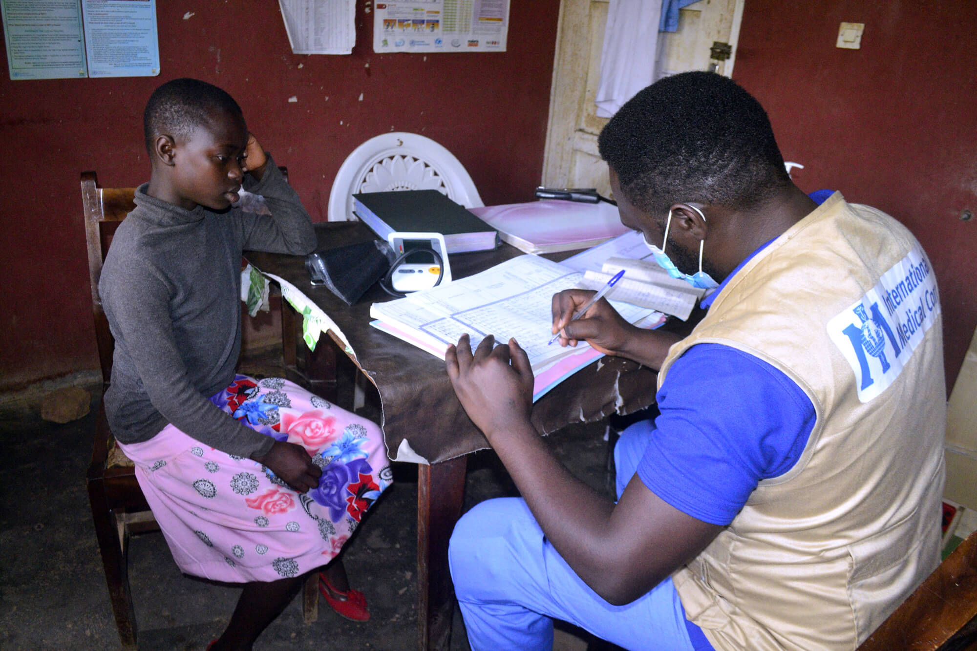 International Medical Corps Nurse Pascal Tikum registers a referred child for a medical consultation at Bome Health center in northwest Cameroon.