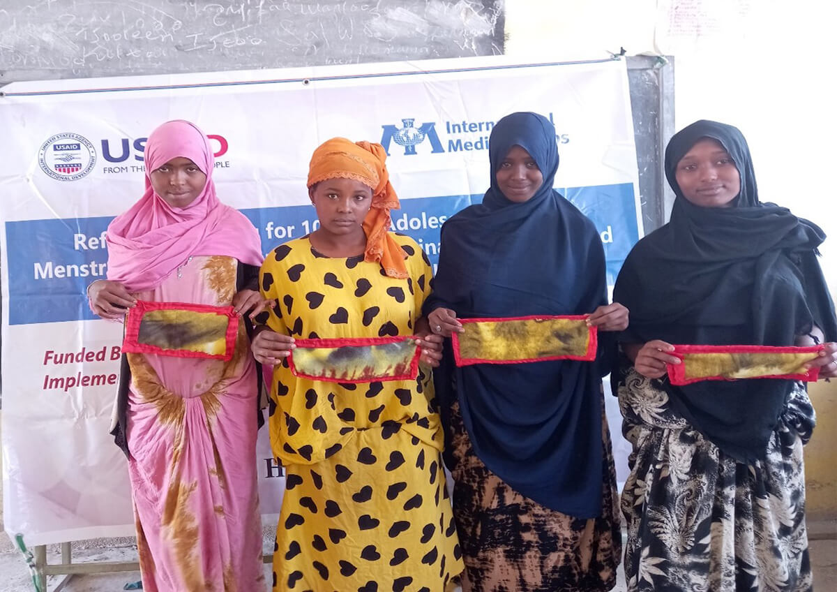 Adolescent girls in Ethiopia learn how to make reusable sanitary pads from cotton cloth at a training session organized by International Medical Corps.
