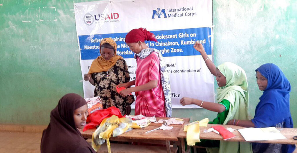 Adolescent girls in Ethiopia learn how to make reusable sanitary pads from cotton cloth at a training session organized by International Medical Corps.