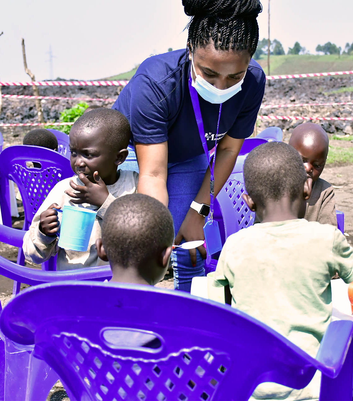 Asha Kisitu assisting children in Mujoga camp.