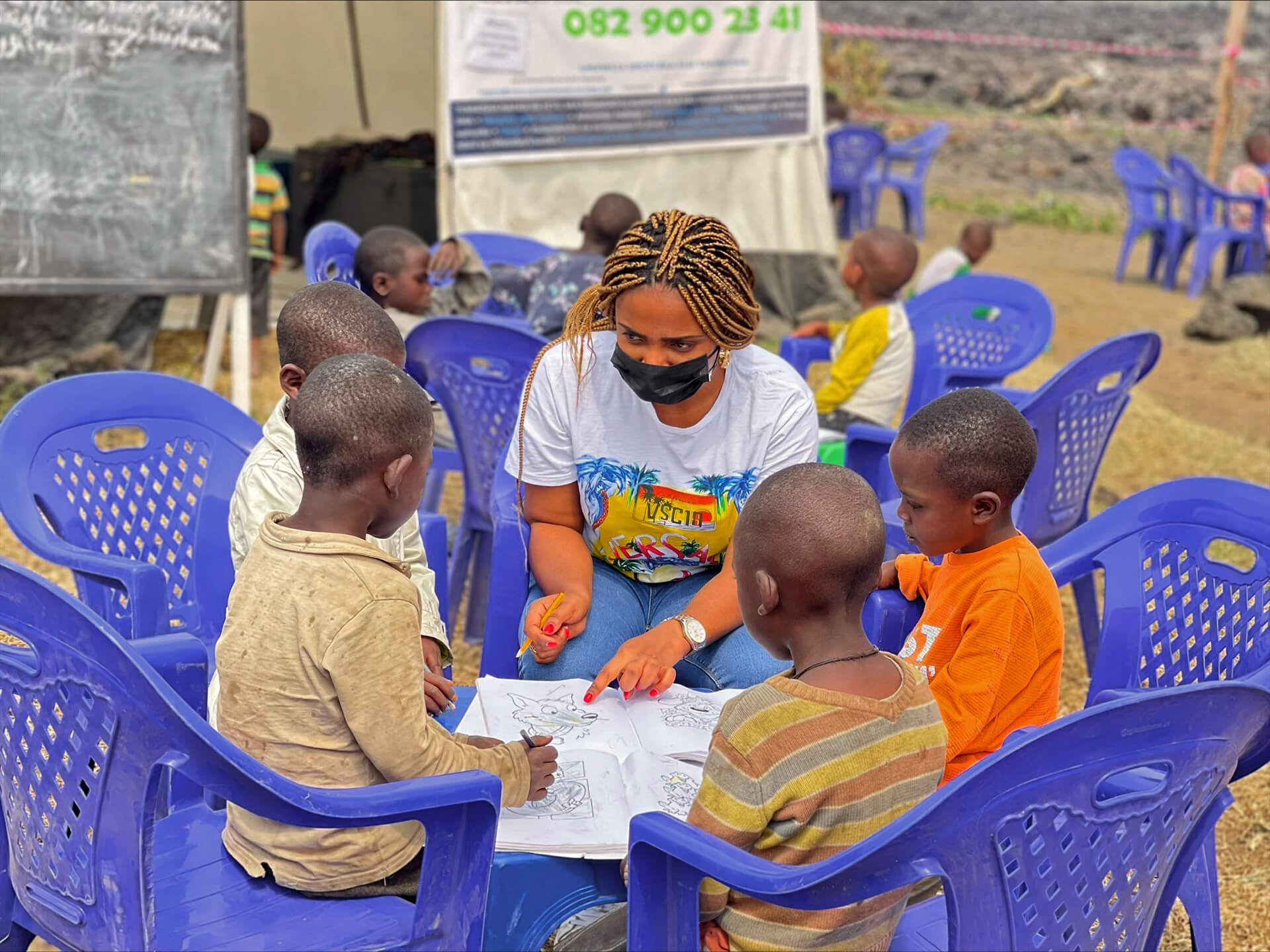 Asha Kisitu plays with children in Mujoga camp.