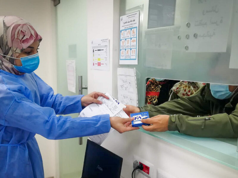 International Medical Corps’ pharmacist dispensing medicine for a beneficiary at the Al Zahraa Primary healthcare center pharmacy.