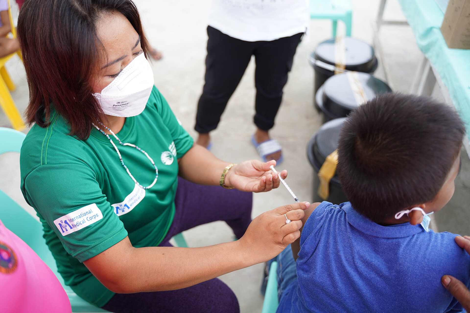 Nurse Marites Solejon administers a COVID-19 vaccine dose to a resident of Halian Island.