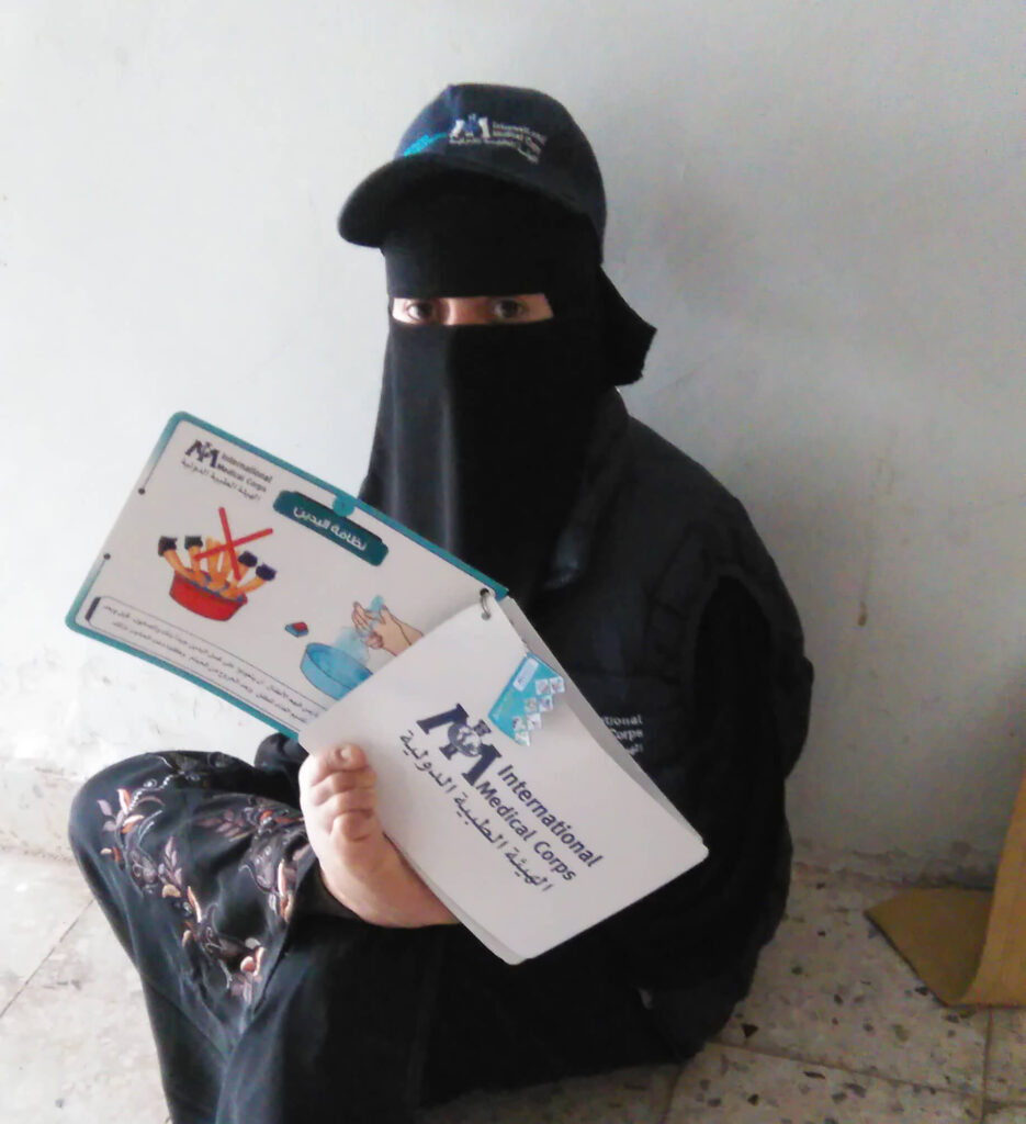 Rezk Allah with instruction material she presented to local residents.
