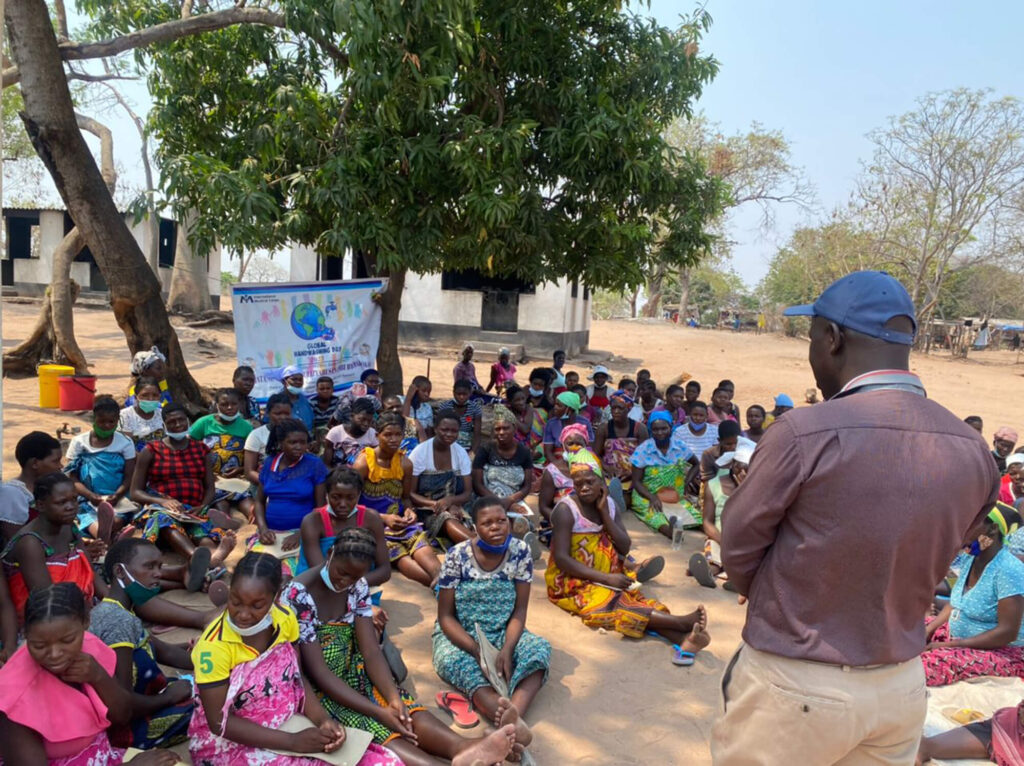 A Ministry of Health District Nutrition Assistant conducts a health education session at Binga Waiting Home.