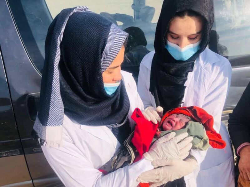 International Medical Corps’ mobile team speaks with the family after the safe delivery of their newborn daughter on a roadside in northern Afghanistan.
