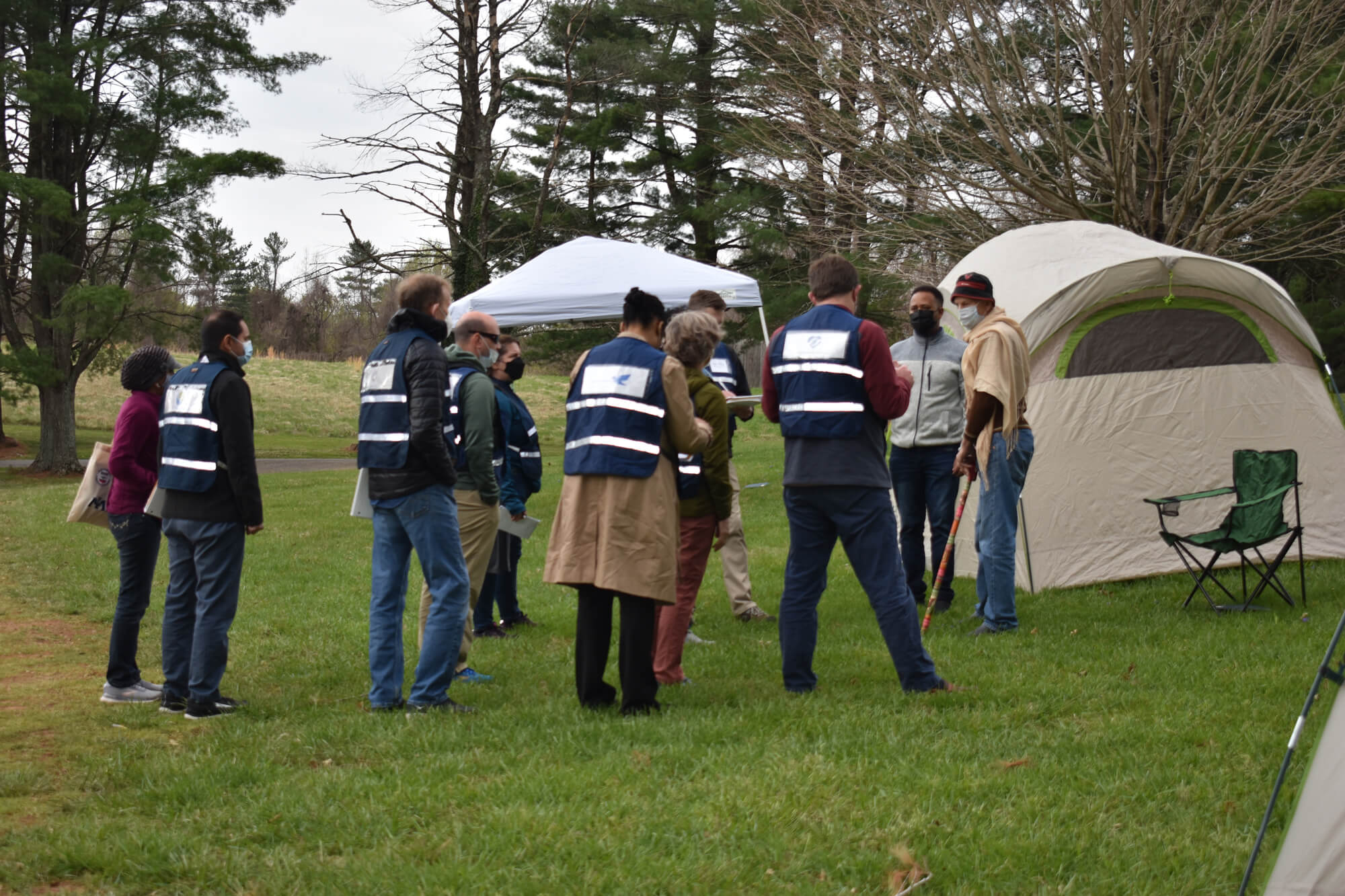 Participants at a disaster-simulation exercise gather information from “survivors” at what remains of their coastal “village,” which according to the scenario provided to participants, had been mostly destroyed a few days earlier by an earthquake and tsunami. The simulation was conducted at a retreat in Airlie, VA.
