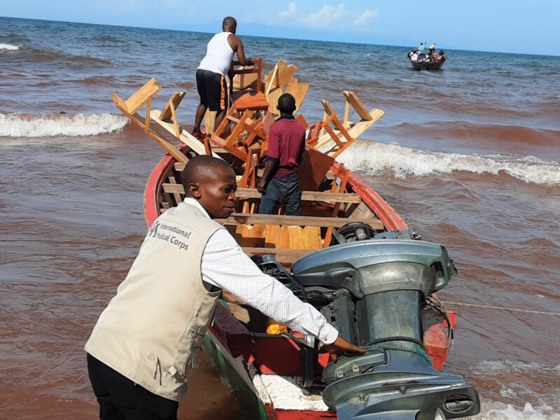 Djaile prepares to board a motorized boat to deliver humanitarian aid to an island in Lake Tanganyika.