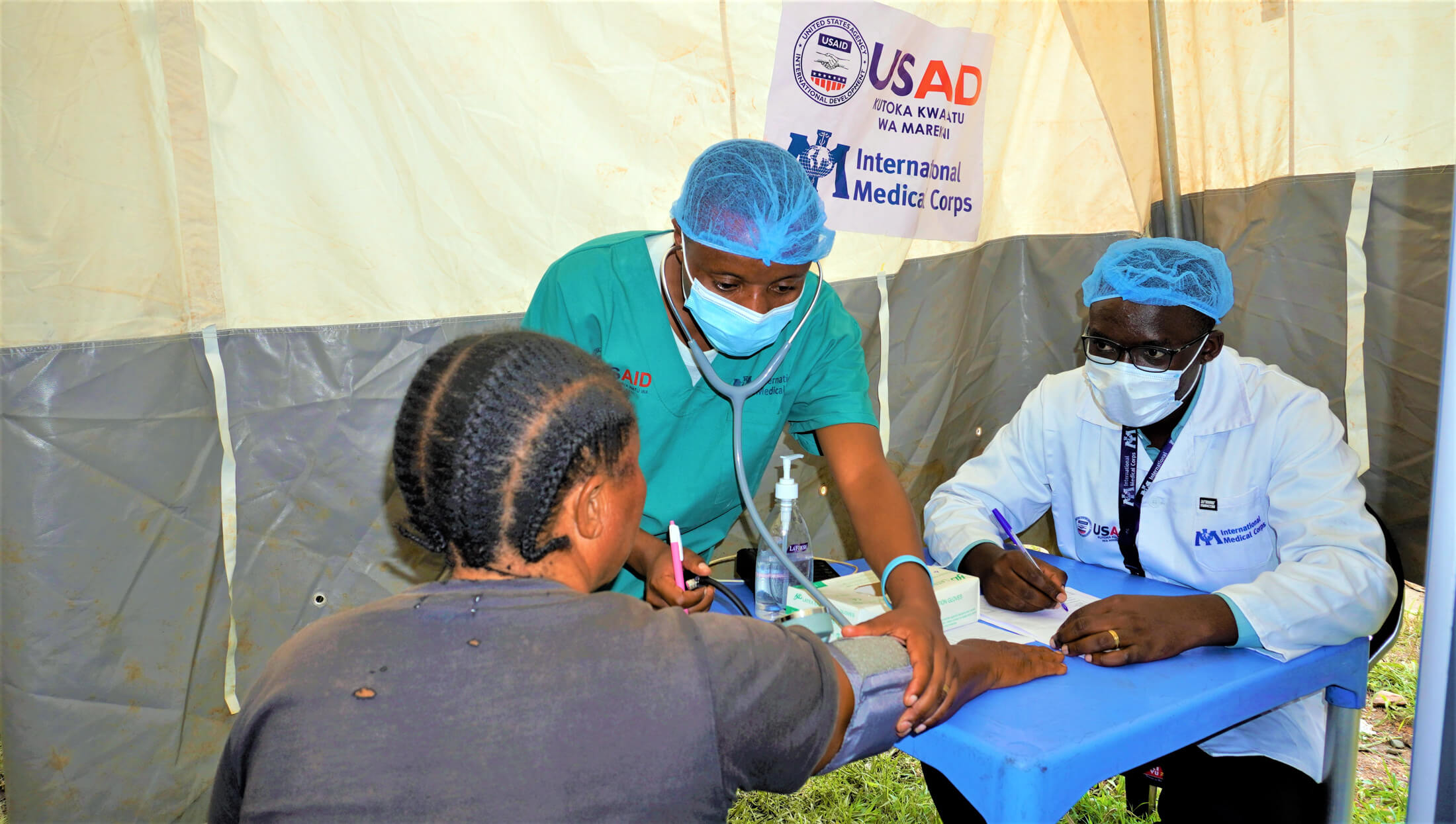 Dr. Zelote consults with a patient at the Minova mobile medical clinic.