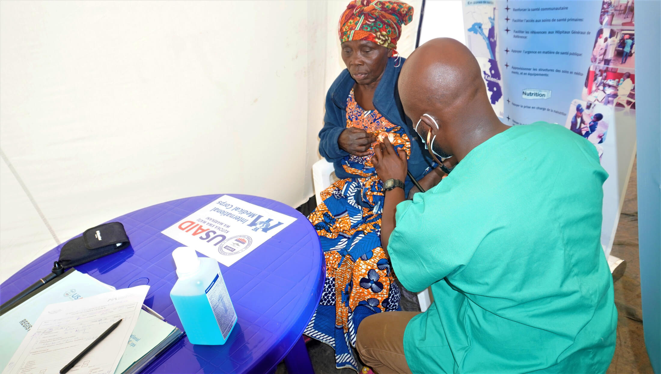 Dr. Bienvenu Mosangu consults with an internally displaced woman during the mobile health clinic.