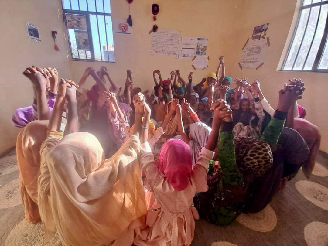Women and girls participate in a life skills session at the WGSS in Chifra.
