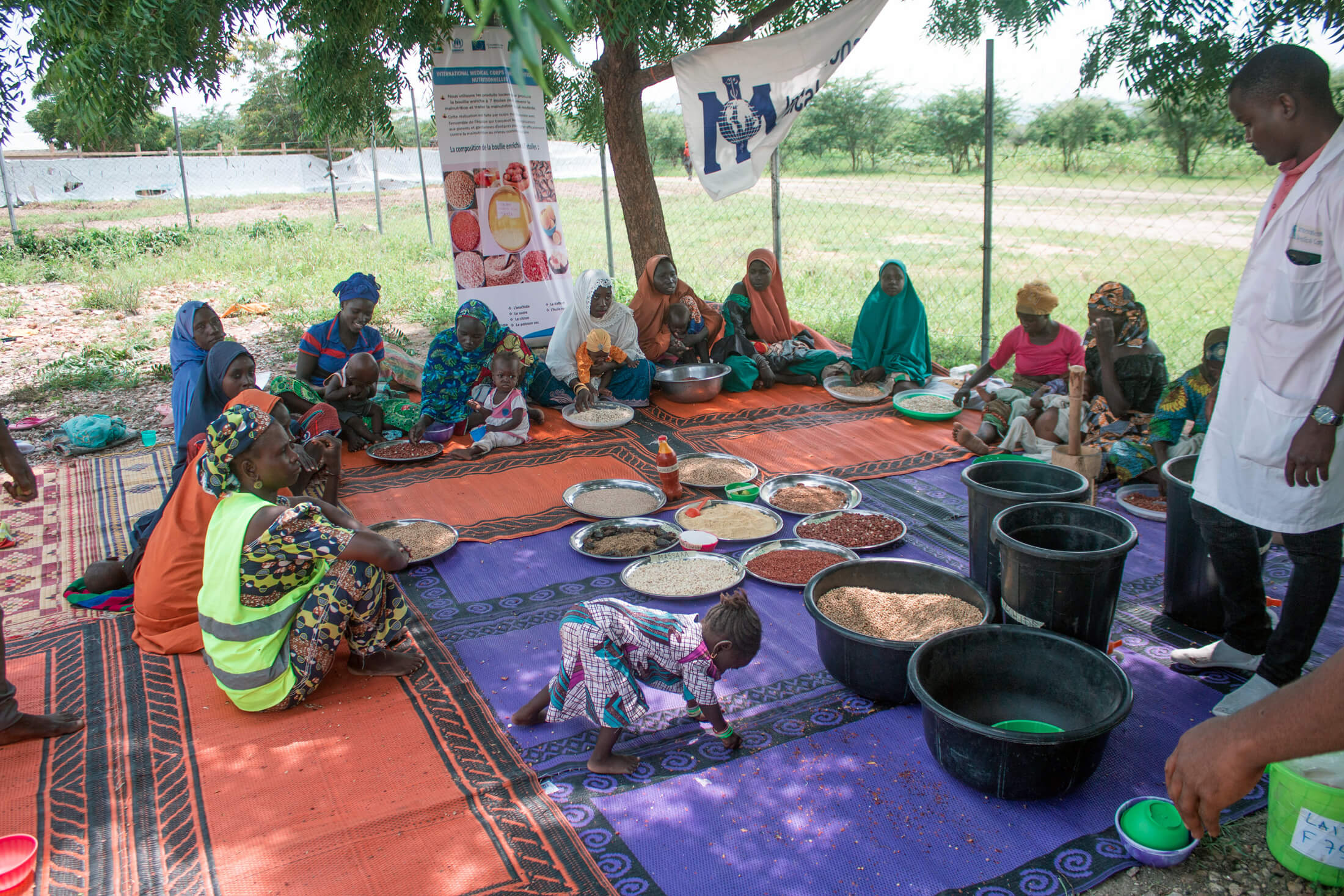 Participants learn about enriched porridge at a cooking demonstration at the Minawao Refugee Camp.