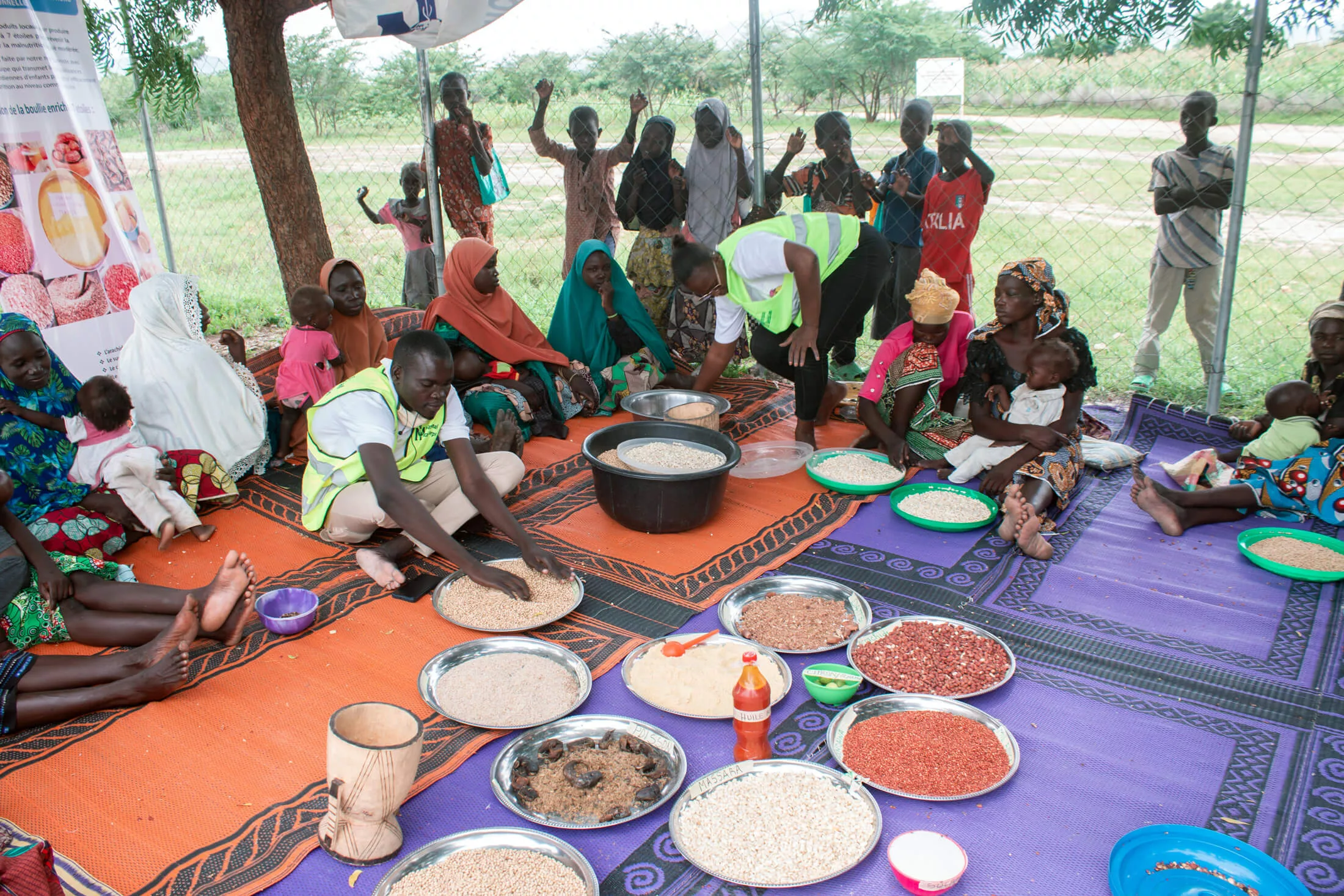 Participants learn about enriched porridge at a cooking demonstration at the Minawao Refugee Camp.