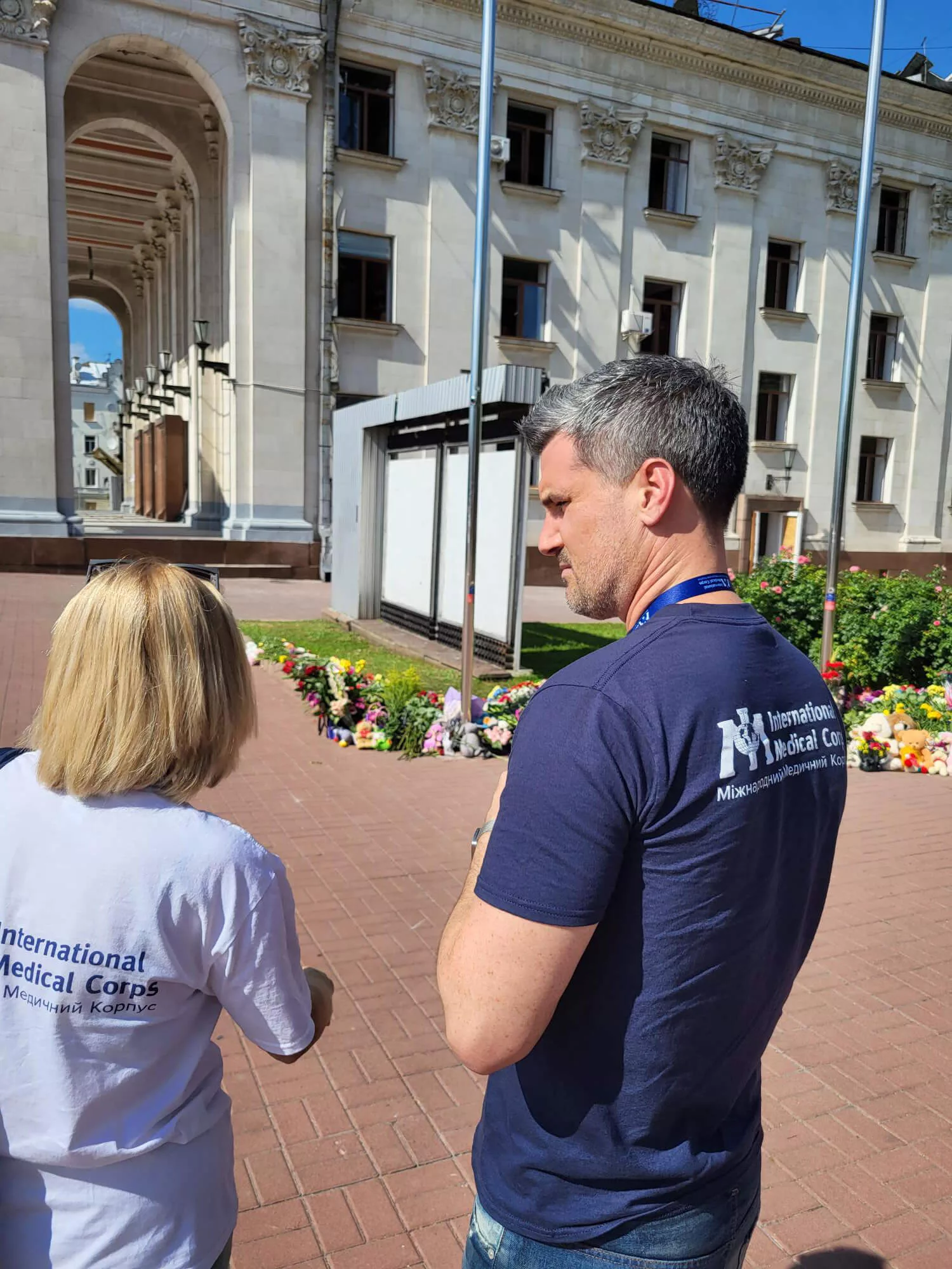 Our Ukraine Program Manager (left) and Country Director(right) speak outside of a theater that was attacked.