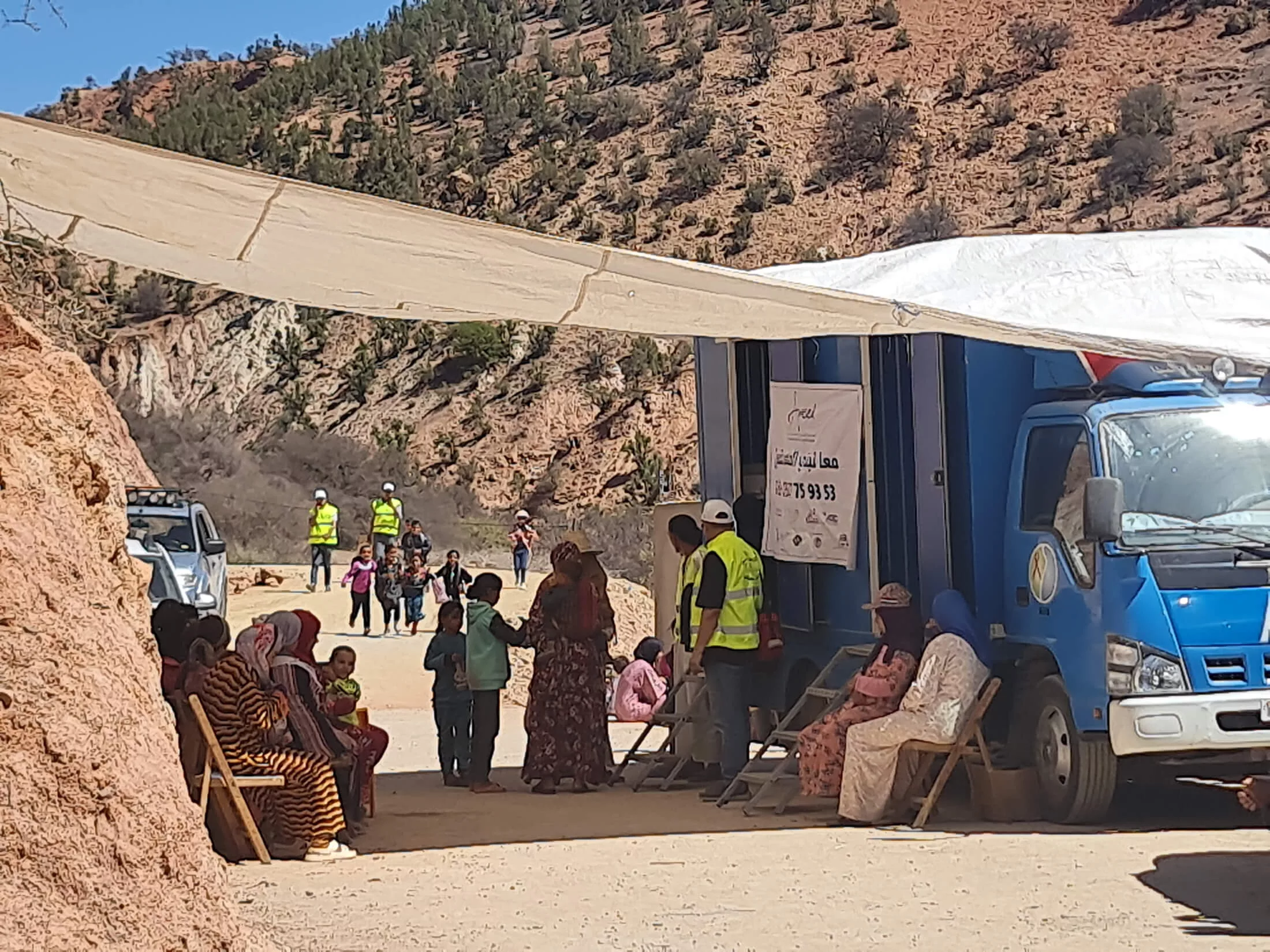 Earthquake survivors wait to be seen at a mobile clinic in northern Ouleid Berhil, Morocco.