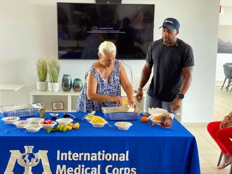 International Medical Corps supporter Kevin Curry conducts a food demonstration for senior citizens at an elder housing center.