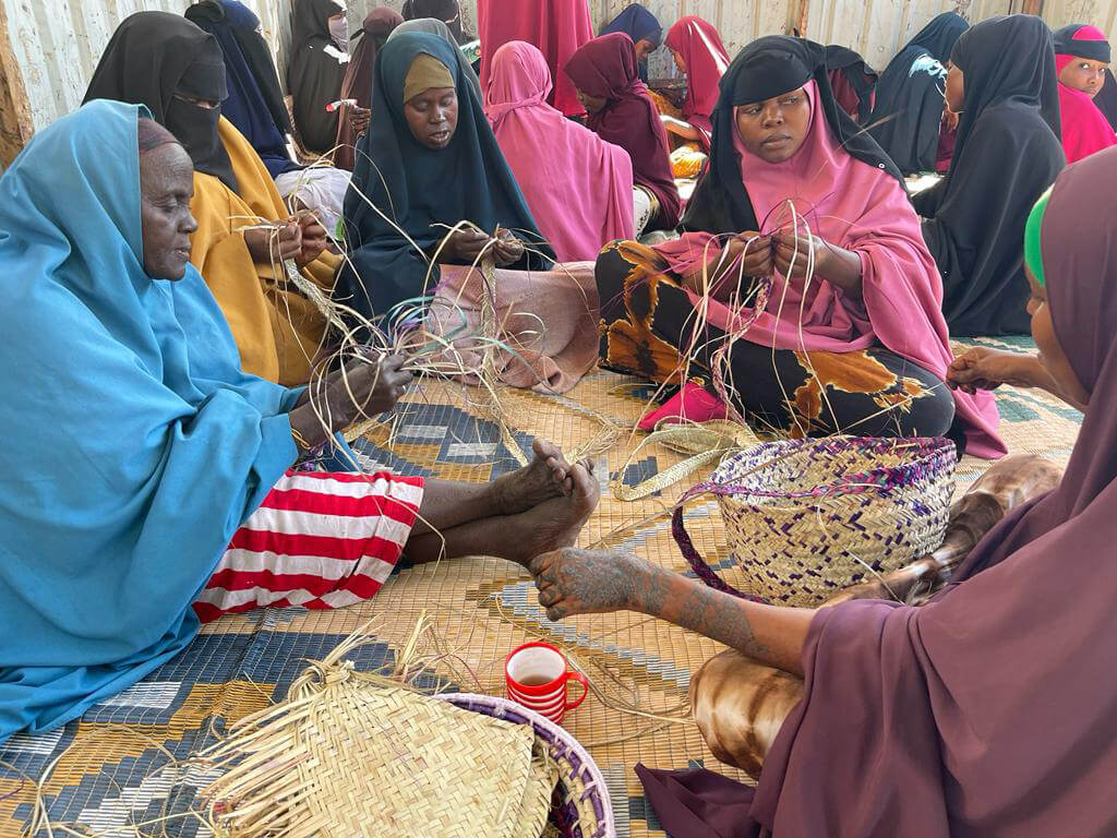Basket weaving is one of the many activities that bring women together at our WGSS. In this photo, women in Somalia practice weaving.