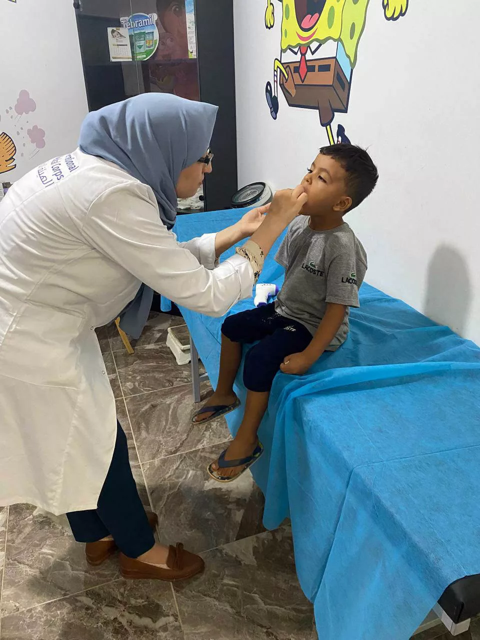 Staff members conduct health consultations and provide supplies at a primary healthcare center in Derna, Libya.