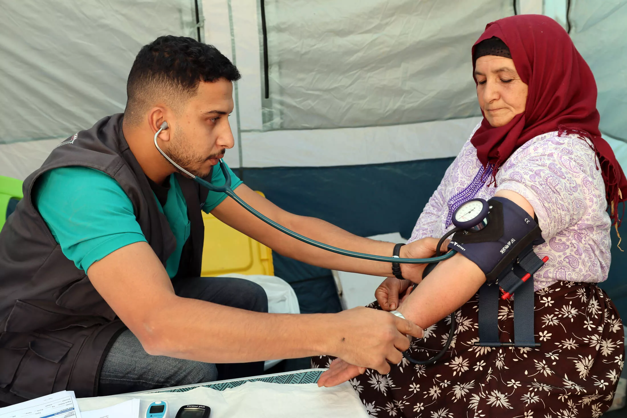 Staff members provide health consultations and routine blood pressure checks on people affected by the Morocco earthquake.