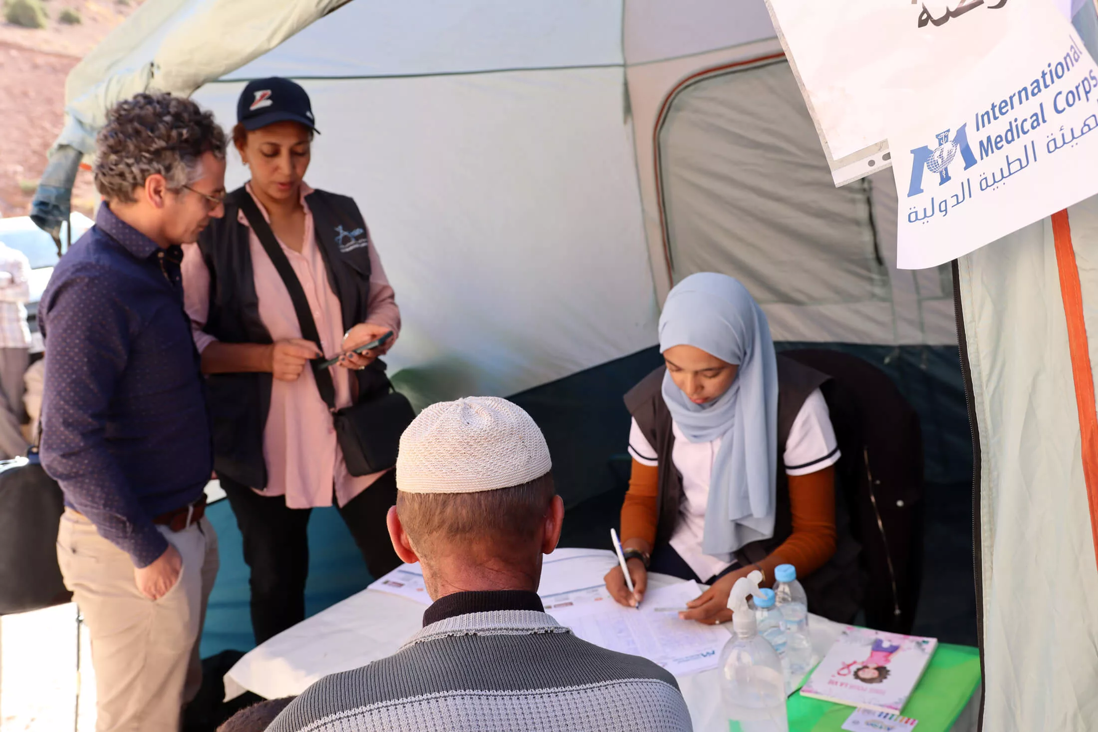 Staff members provide health consultations and routine blood pressure checks on people affected by the Morocco earthquake.