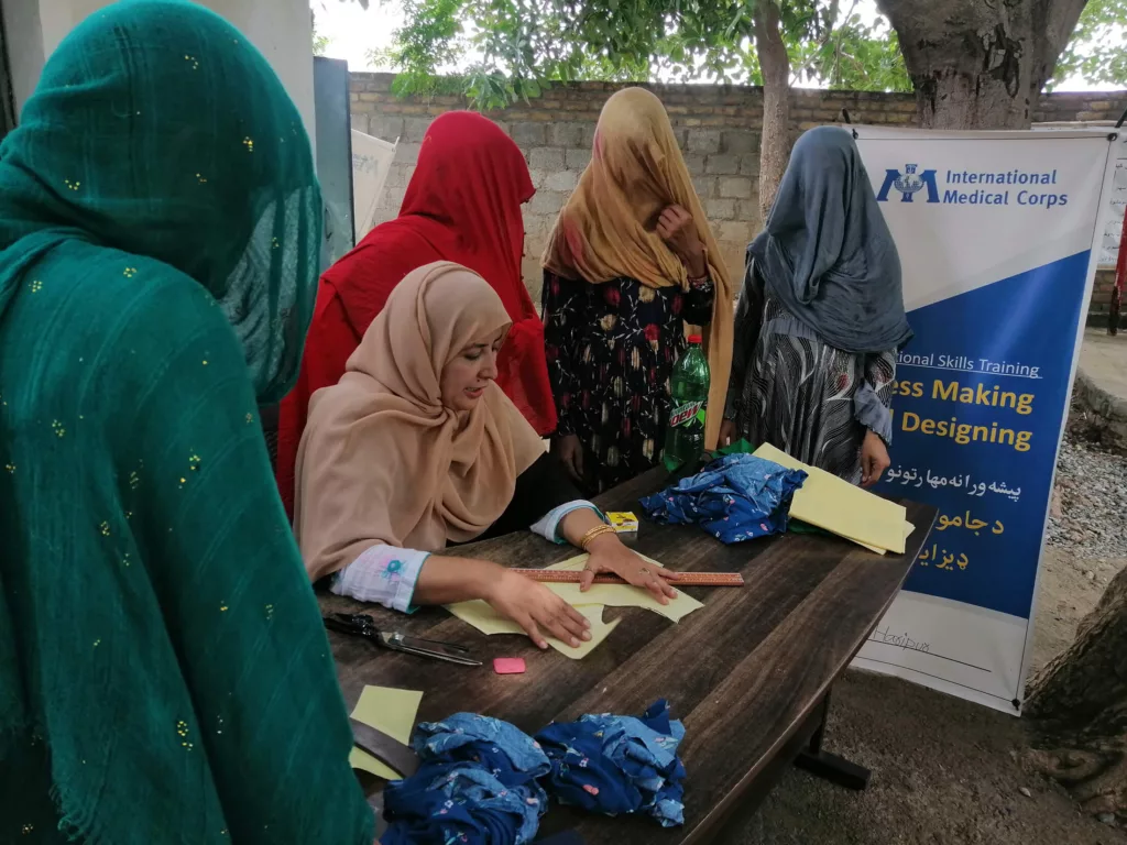 Rabia and her fellow trainees learn how to draft sewing patterns during a vocational-skills training program in Khyber Pakhtunkhwa, Pakistan.