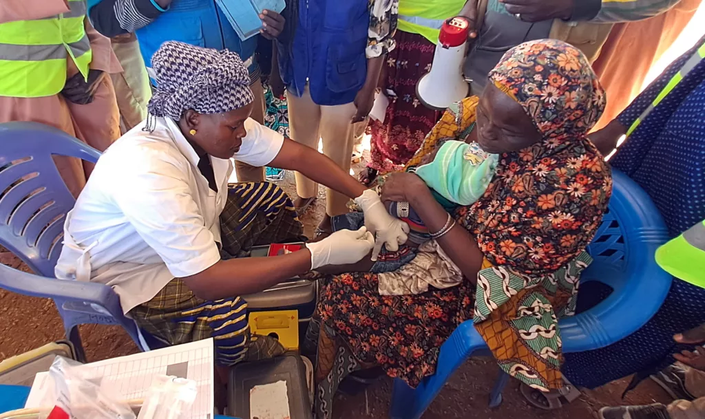 A community health worker in Cameroon vaccinates a 6-month-old child against malaria in the world’s first routine immunization program against the disease.