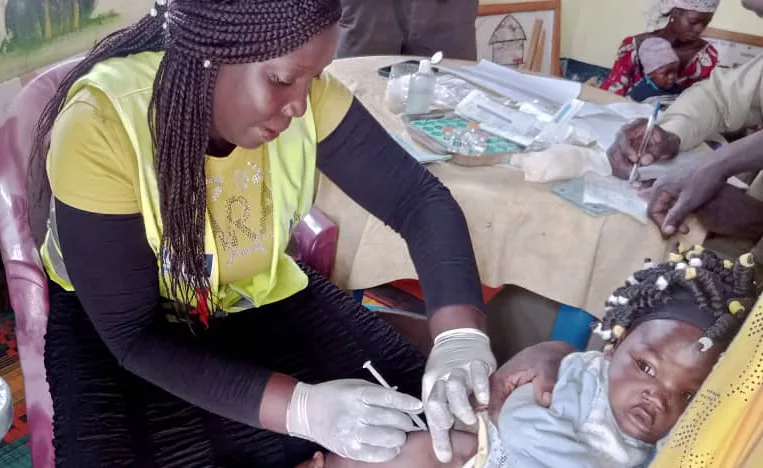 A child receives the first of four immunization injections as part of Cameroon’s vaccination campaign against malaria.