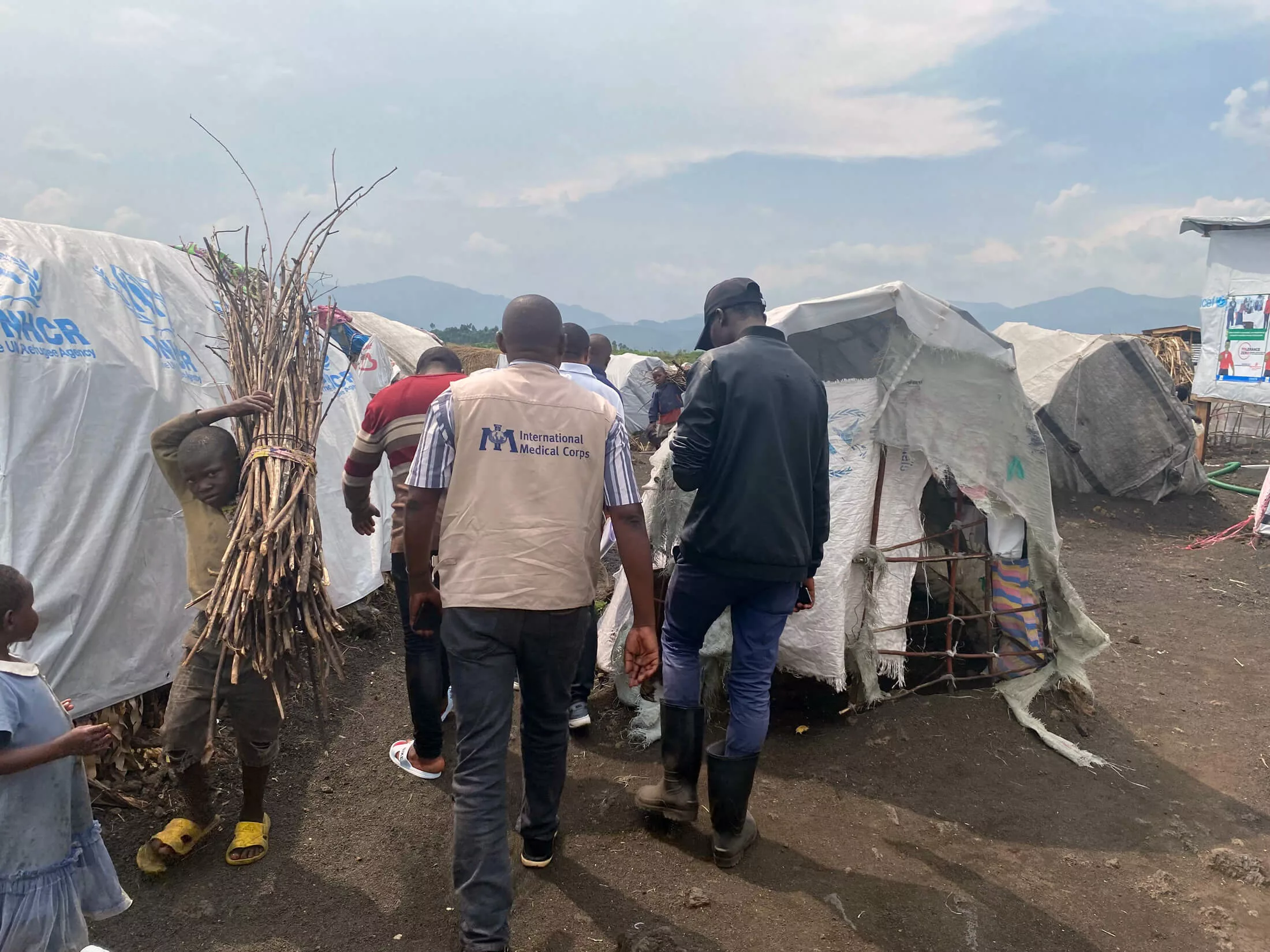 Our team walks with the managers of the Kyabiringa IDP camp, where we offered care during the armed conflict outside of Goma, DRC.