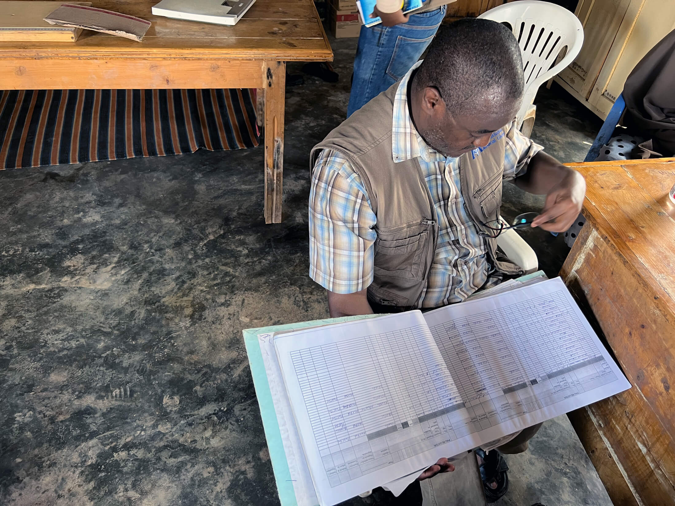 Njoroge Kamau reviews health facility data in Jowhar, Somalia.