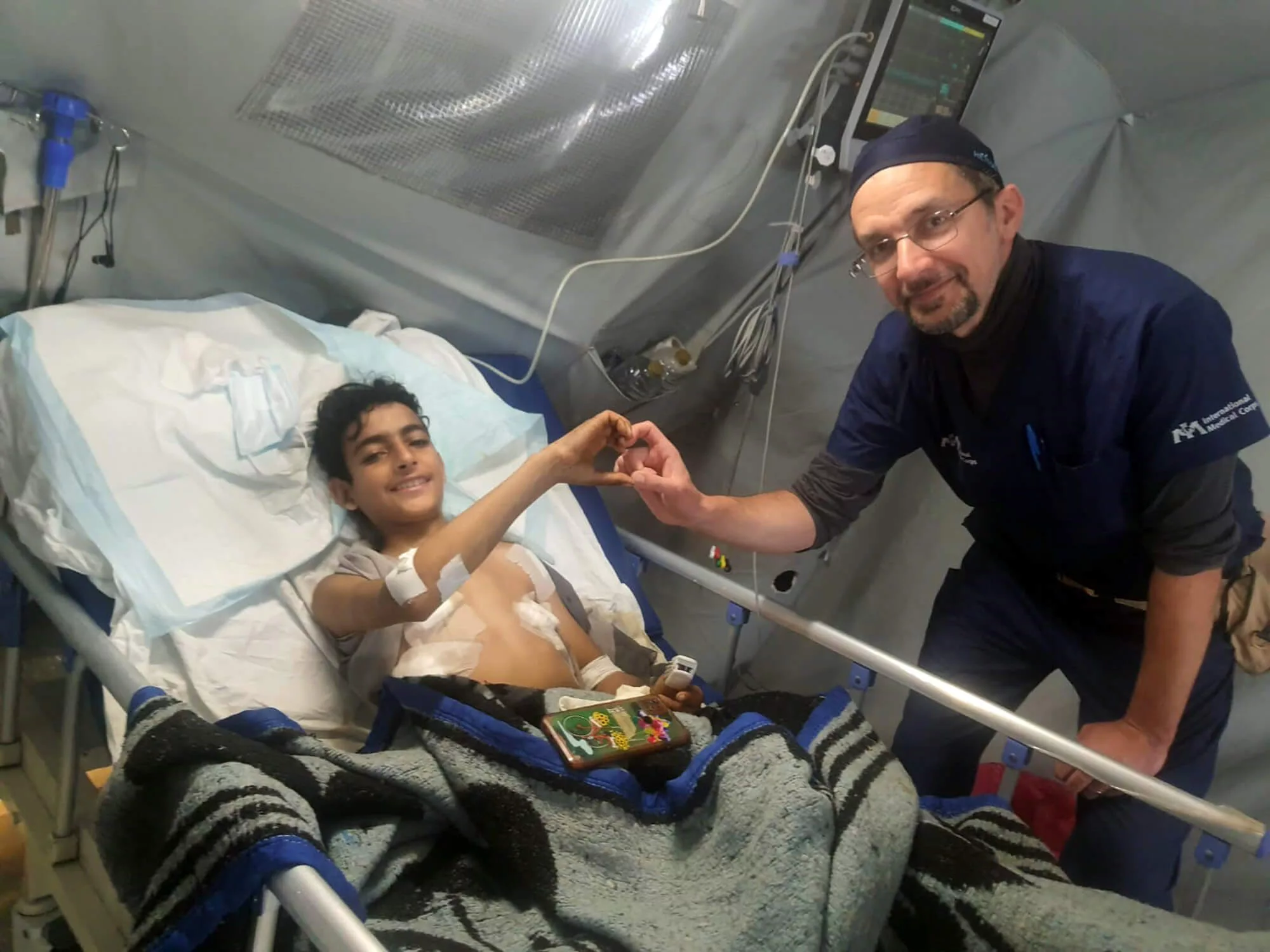 Dr. Haitham Qandeel follows up with a boy on whom he performed a lifesaving surgery.