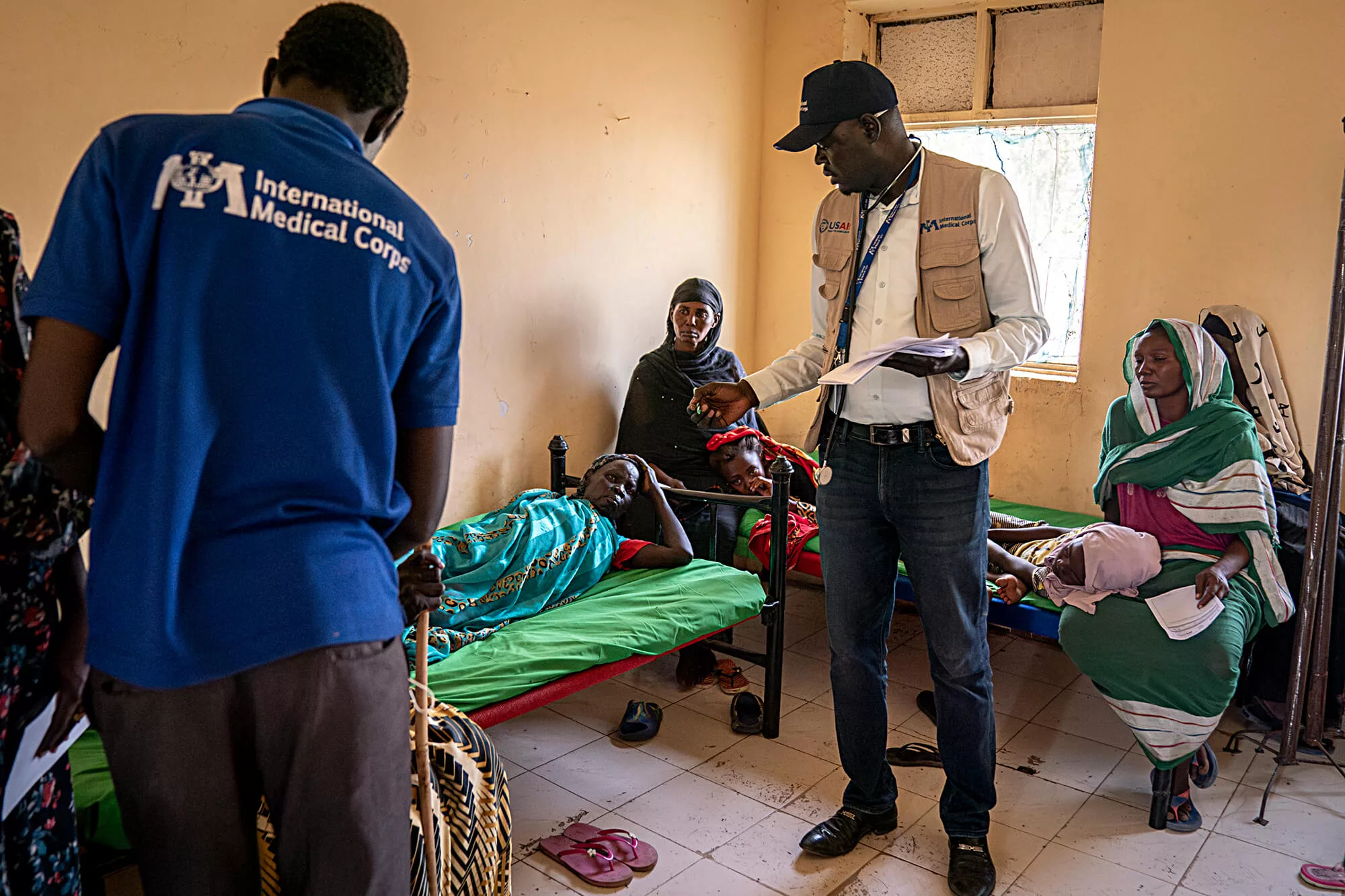 Dr. William and other staff members meet with patients at one of the International Medical Corps health clinics in Renk, South Sudan.