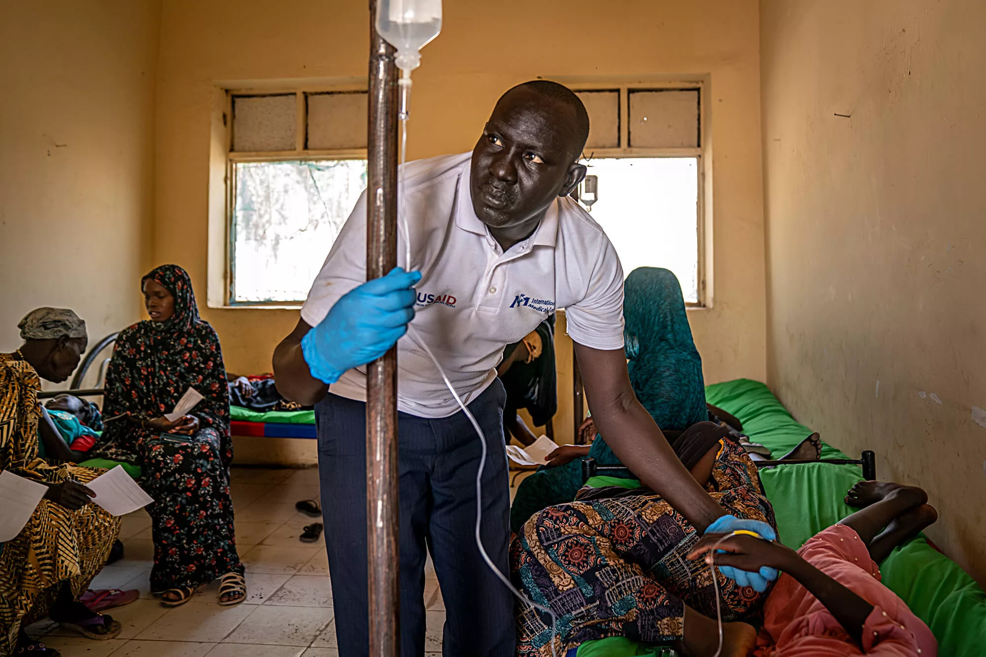 An International Medical Corps nurse administers an IV for Sabrina Abdulatif, 16 years old, who arrived at the health clinic in Renk with complaints of a fever, headache and body pain.