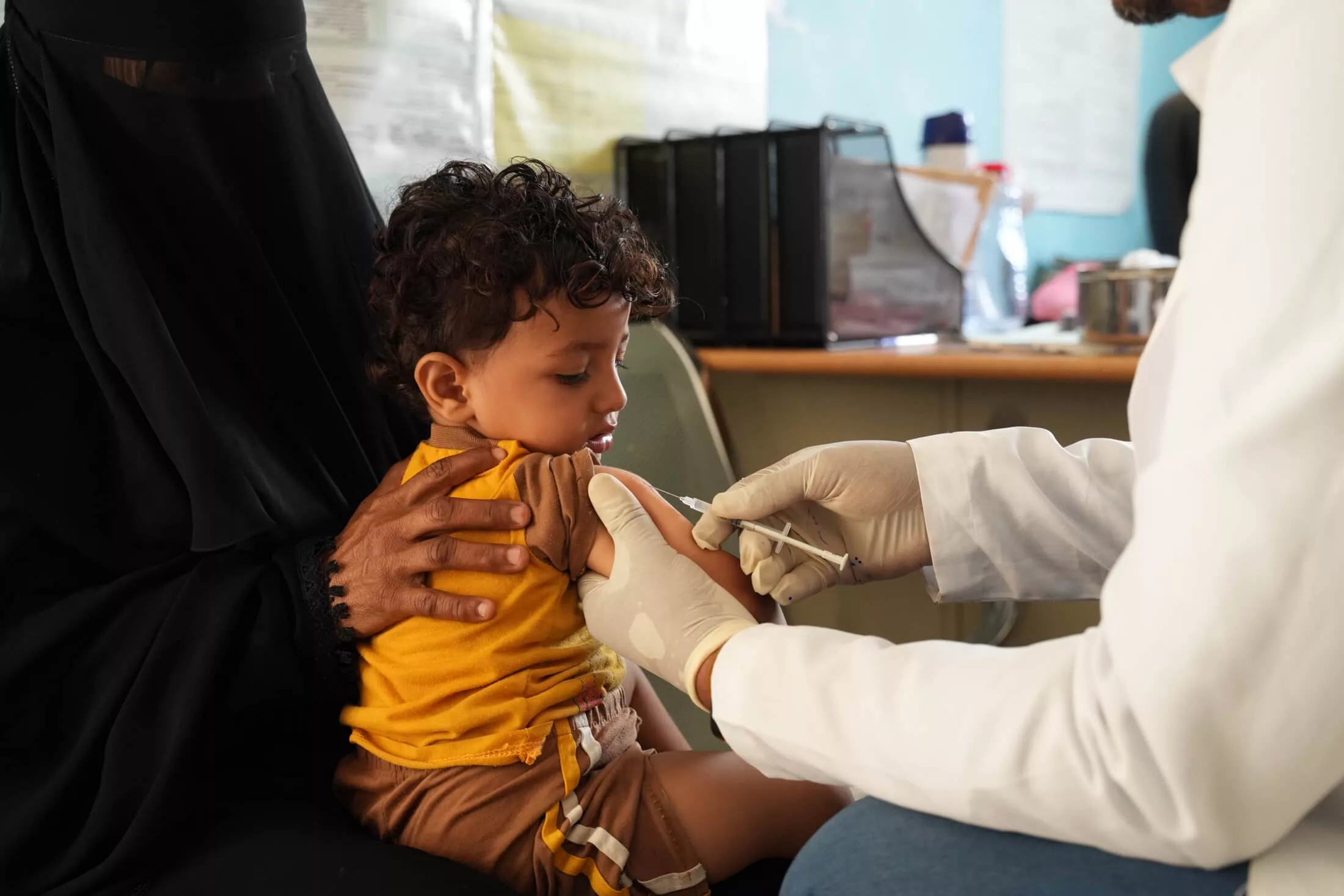 Health Worker Faud Mohsen Hendy Sabr Ali gives a measles vaccine to 2-year-old Radad Labib at Gol Madram Health Unit in Al Musaymir district, Lahj governorate.